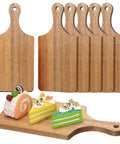 Front view of six acacia wood cutting boards with handles and hanging holes for chopping and serving