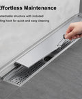 Heavy Duty Stainless Steel Linear Shower Drain With Hidden Wall Design For Sleek Bathroom Setup showing maintenance with lifting hook.