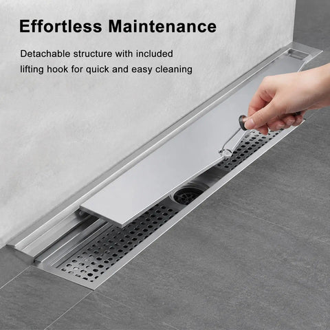 Heavy Duty Stainless Steel Linear Shower Drain With Hidden Wall Design For Sleek Bathroom Setup showing maintenance with lifting hook.