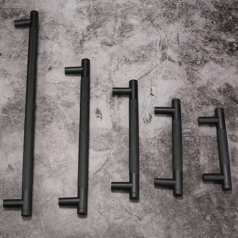 10 Pack 5 Inch Knurled Cabinet Pulls Matte Black Drawer Handles displayed on surface, showcasing different lengths and textured grip.