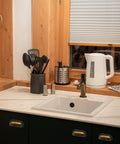 Antique Brass Cup Pulls 2.5 Inch Center To Center Kitchen Cabinet Handles in a farmhouse style kitchen setting