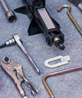 Pro-Grade Aluminum Dent Puller Rings Kit for Auto Body Repair alongside various auto tools on a garage floor