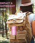 Pink LED Camping Lanterns With Portable Handle hanging on a tan backpack in forest, compact design for hiking