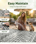 Woman cleaning Waterproof 5x8 Outdoor Rug Mat For Patio Balcony RV Camping And Beach Reversible Boho Gray Plastic Straw Pattern