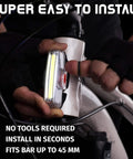 Cyclist installing USB Rechargeable Bike Front Light with 200 Lumen LED Output for Day and Night Visibility on bicycle bar