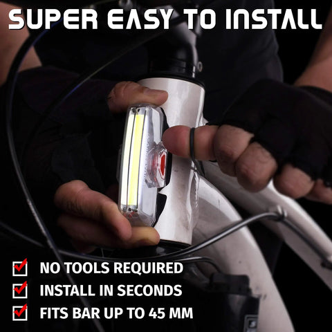 Cyclist installing USB Rechargeable Bike Front Light with 200 Lumen LED Output for Day and Night Visibility on bicycle bar