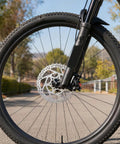 Complete Hydraulic Disc Brake Conversion Kit For Mountain Bikes With Two Ventilated Steel Rotors And Heavy Duty Metal Levers installed on a front wheel.