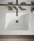Roomy Rectangular Undermount Bathroom Sink With Overflow Drain Crafted From Hella Durable Vitreous China For An Easy Vanity Setup Bringing Straight Up White Finish And Really Smooth Daily Performance viewed from above on marble countertop.