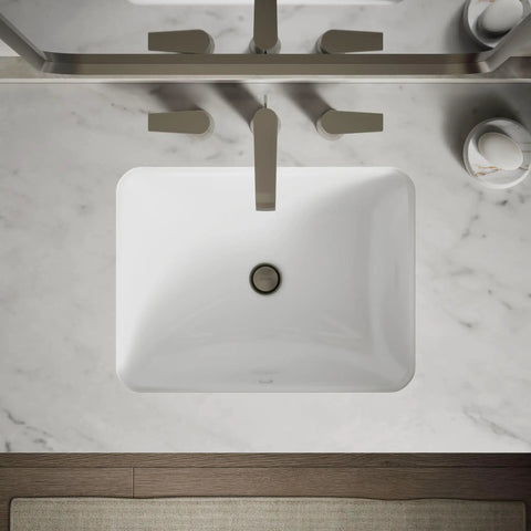 Roomy Rectangular Undermount Bathroom Sink With Overflow Drain Crafted From Hella Durable Vitreous China For An Easy Vanity Setup Bringing Straight Up White Finish And Really Smooth Daily Performance viewed from above on marble countertop.