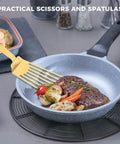 Snailhouse gold slotted spatula, stainless steel high-heat turner for flipping meat and vegetables in a grey pan