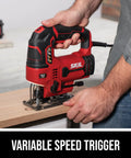 Badass Six Amp Corded Jigsaw With No Sweat Tool Swap And Four Stage Orbital Action Plus Slick Variable Trigger For Fast Smooth Cuts Through Wood And Metal Built Tough For Weekend Warrior Diy Renos And Serious Shop Tasks in use cutting wood with variable speed trigger visible.