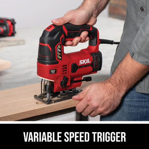 Badass Six Amp Corded Jigsaw With No Sweat Tool Swap And Four Stage Orbital Action Plus Slick Variable Trigger For Fast Smooth Cuts Through Wood And Metal Built Tough For Weekend Warrior Diy Renos And Serious Shop Tasks in use cutting wood with variable speed trigger visible.