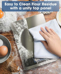 Hand cleaning Digital Kitchen Scale With 22Lb Capacity, Precise 1g And 0.1oz Increments on a messy counter.