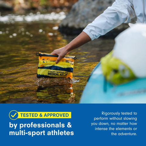 Person holding Ultralight Watertight Medical Kit.9 For Up To 4 People And 4 Days in water, showcasing waterproof design.