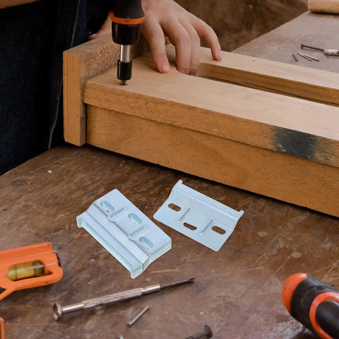 Person installing wood cabinet using drill and Heavy Duty Wall Cabinet Mounting Brackets Set Of 10 For Wood Cabinets Iron Flat Shelf Brackets