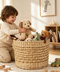 Large Water Hyacinth Storage Basket 15.7 Inch Woven Seagrass Bin With Sturdy Design filled with toys and a child playing.