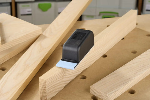 Pocket StickFix Hand Sanding Block With Quick Change Hook And Loop System on wood surface, compact grip shown.