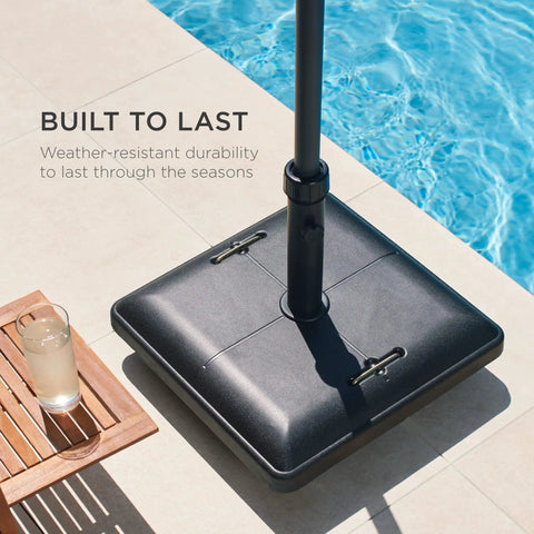 81 Pound Heavy Duty Concrete Rolling Umbrella Base With Locking Wheels And Collapsible Handles by a poolside