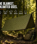 Woobie Blanket Insulated Water Resistant Poncho Liner set up as a shelter between trees in a forest with boots and backpack.