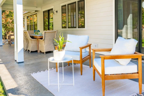 Outdoor patio with white wall seating area, weatherproof furniture, and view of a porch. Built Tough Heavy Duty 1-Gang Recessed Weatherproof In-Use Outlet Cover 6-In-1 Nonmetallic Design Horizontal Or Vertical Mount White Recessed Enclosure For Indoor Or Outdoor Outlets not shown.