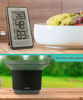 Indoor Outdoor Thermometer With Wireless Sensor, Humidity Monitor, And 24 Hour Display on kitchen counter