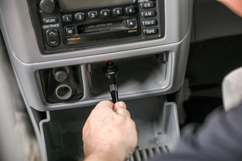Black Quarter-Inch Drive Mini Ratchet With 90-Tooth Swivel Head, 250-Degree Range, Chrome Moly Steel Gears, Rust-Resistant Anodized Head, Knurled Grip, Compact Design For Tight Spaces And Quick, Smooth Turn used in a car console