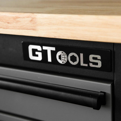 Close-up of ‘GT TOOLS’ logo on the drawer of Heavy Duty Steel Rolling Tool Chest With Fourteen Deep Full Extension Drawers And Massive Mega Top Tray For Garage Organization Grease Monkey Approved Workhorse Cabinet.
