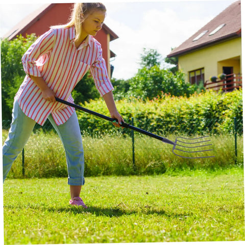 Woman using Handheld Manure Fork For Farm And Home Use, Multi Functional Yard Tool For Lawn Maintenance And Grass Clearing