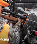 Hunter using Stronghold Gun Boot L With Autolatch Mount Black Hard Case For Long Guns Up To 52 Inches in snowy outdoor setting