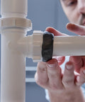 Person applying Two Ounce Epoxy Putty Stick That Delivers A Fast Hardcore Waterproof Bond For Cars Boats Plumbing And Home Repairs Cures Dark Gray Heat Resistant Up To 350 Fahrenheit Holds Four Tons Chemical And Fuel Resistant on pipe joint
