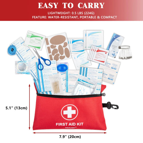 Front view of red Atickyaid mini first aid kit opened with bandages, scissors, and small supplies spilling out