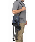 Man carrying Quik-E-Seat Portable Folding Tripod Chair With Drink Holder And Padded Lumbar Support for festivals and camping.