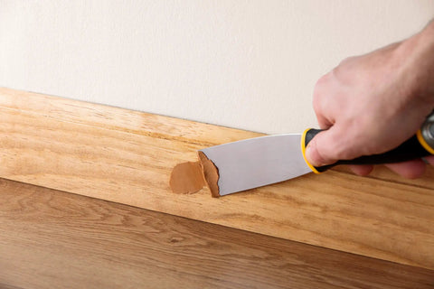 Applying White Wood Putty For Quick Fix Of Minor Scratches And Nail Holes, Non Hardening Pre Mixed Formula to wood trim with putty knife