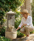 Woman admiring a Massive Outdoor Wall Fountain With LED Lights 42.91 Inch Tall Freestanding Garden Water Feature