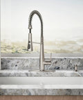 Slick Stainless Steel Kitchen Sink Faucet With Built In Soap Dispenser And Heavy Duty Pull Down Sprayer showcased on a granite countertop.