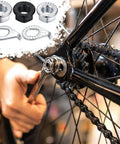 Installing 24Pcs Bicycle Axle Nut Kit with Safety Washers on bike, includes flanged wheel nuts for M8 M9.5 M10 hubs.