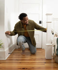Man measuring banister height for Banister To Banister Gate Mounting Kit For Round Or Square Banisters Up To 37 Inches Tall.