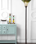 Bronze Botanical Tiffany-Style 71-Inch Torchiere Floor Lamp With Dope Handcrafted Stained Glass Bowl Shade in a living room setting
