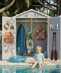 Child sitting by pool with open 6x4.4 Ft Resin Outdoor Storage Shed With Floor Lockable Doors, displaying beach gear inside