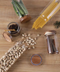 Straight Up Solid Airtight Coffee And Tea Storage Canister With Smooth Wood Lid storing coffee beans, pasta, and snacks on wood countertop.