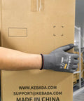 Person wearing W1 PU Coated Work Gloves For Men And Women With Grippy Touchscreen Compatibility handling a box in a warehouse