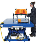 Heavy Duty Welded Steel Electric Hydraulic Lift Table With 48 By 72 Platform And 6000 Lbs Capacity Built Like A Brick House For Industrial Shops Osha Toe Guard Blue Finish in use.