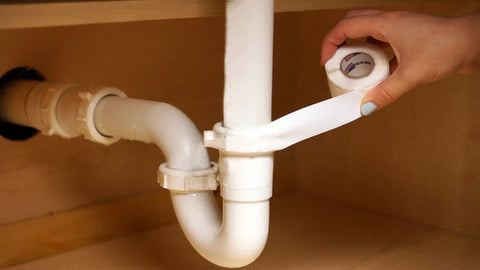 DIY Quick Leak Fix Tape For Under Sink Pipes No Adhesive Self Fusing Silicone Wrap applied on white PVC plumbing