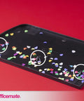 Confetti tray showing colorful paper circles from 3 Hole Punch for Home Office, Medium Duty, 30 Sheet Capacity, Black, Metal Base