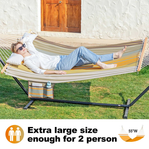 Waterproof Double Hammock With Stand For Outdoor Hangout Heavy Duty Two Person 55 Inch Quick Dry Textilene Hammock is set up on grass with a person relaxing on it, showing hardwood spreader bar and side pocket.