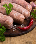 Get The Most Dope Sausage Making Gear With 4000 Heavy Duty Aluminum U Clips For Your Manual Clipper That Hold Tight And Never Bend During Any Crazy Meat Day, with fresh sausages and red chili.