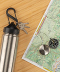 Stainless steel bottle attached with SBiner Plastic Dual Carabiner Four Black Two Pack Lightweight Glass Filled Nylon, keys, map, and compass.