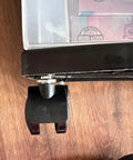 Two black 1.5-inch replacement caster wheels for Sterilite 3-drawer carts, shown on wood floor.