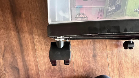 Two black 1.5-inch replacement caster wheels for Sterilite 3-drawer carts, shown on wood floor.