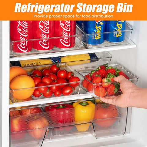 Inside a refrigerator with clear storage bins holding canned drinks, strawberries, bell peppers, tomatoes, and pasta.